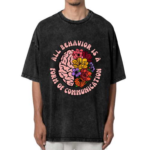 Product image of washed graphic T-shirt featuring 'All Behavior Is Communication' statement design
