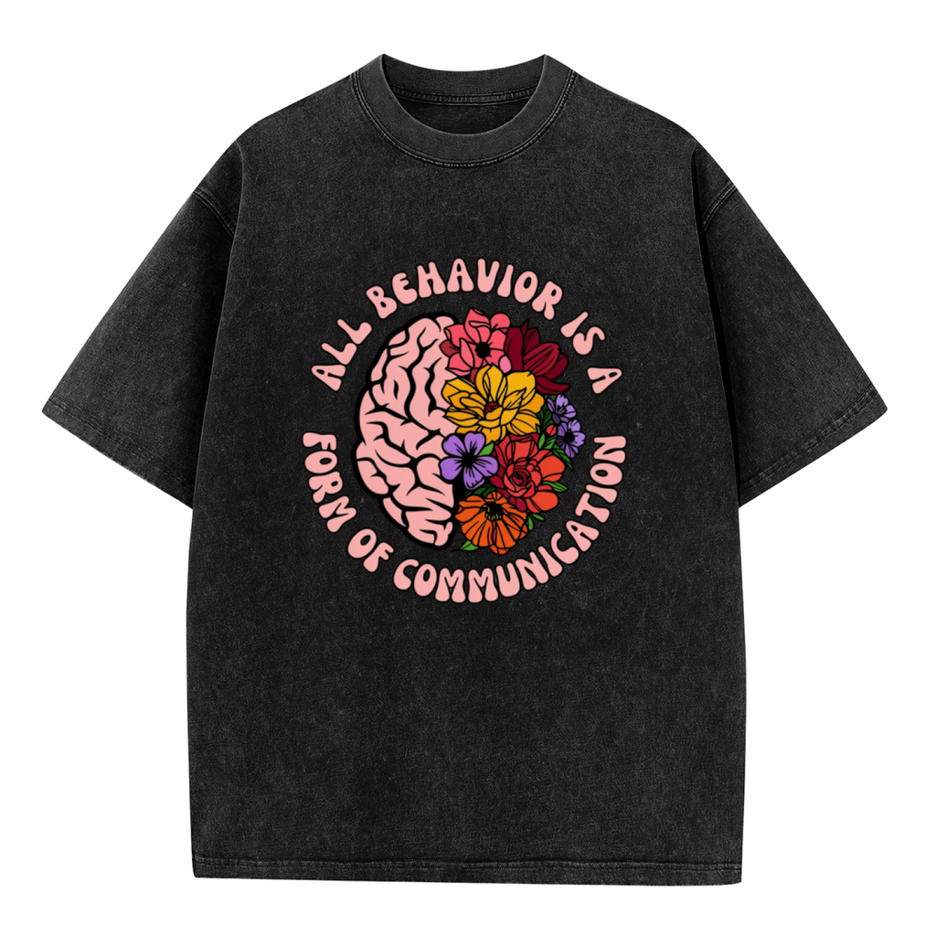 Product image of washed graphic T-shirt featuring 'All Behavior Is Communication' statement design