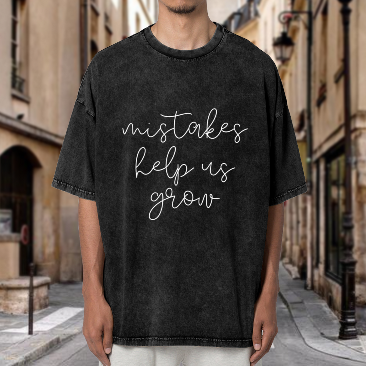 Product image of washed graphic T-shirt featuring 'Mistakes Help Us Grow' statement design