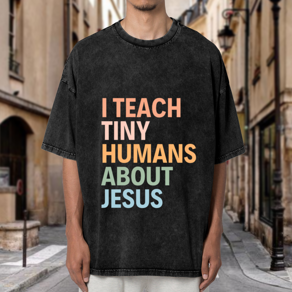 Unisex washed graphic T-shirt with I Teach Tiny Humans About Jesus themed design, product image
