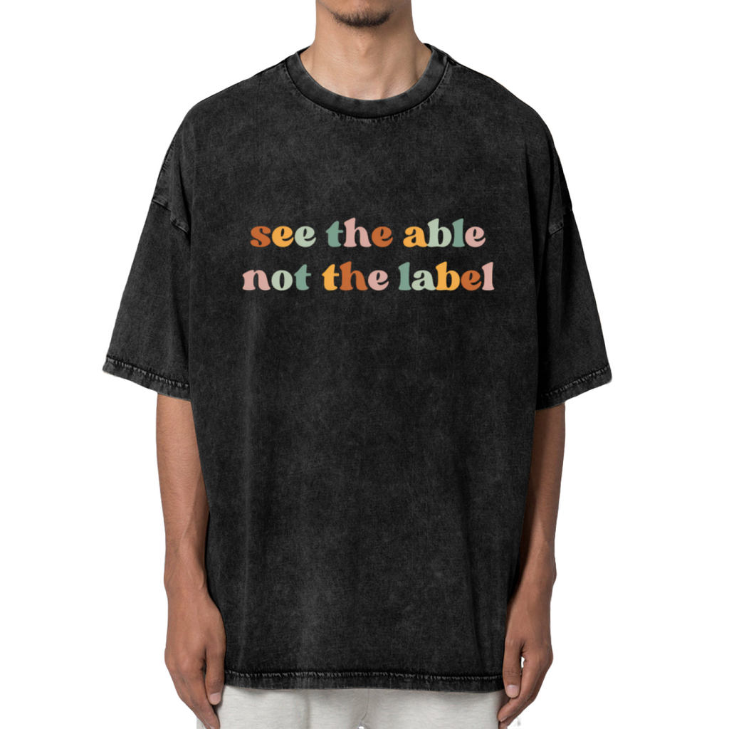 Unisex washed graphic T-shirt with See The Able Not The Label themed design, product image