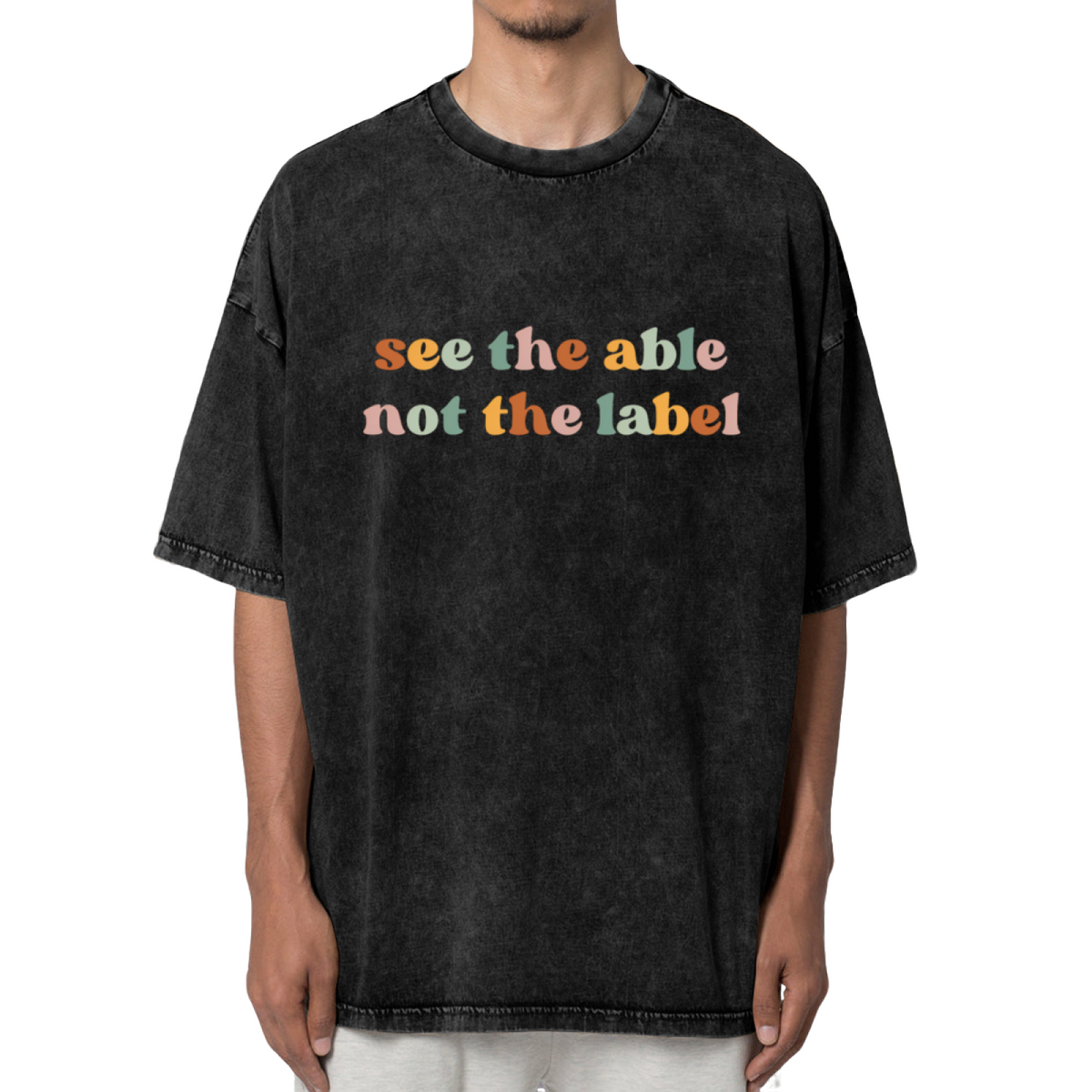 Unisex washed graphic T-shirt with See The Able Not The Label themed design, product image