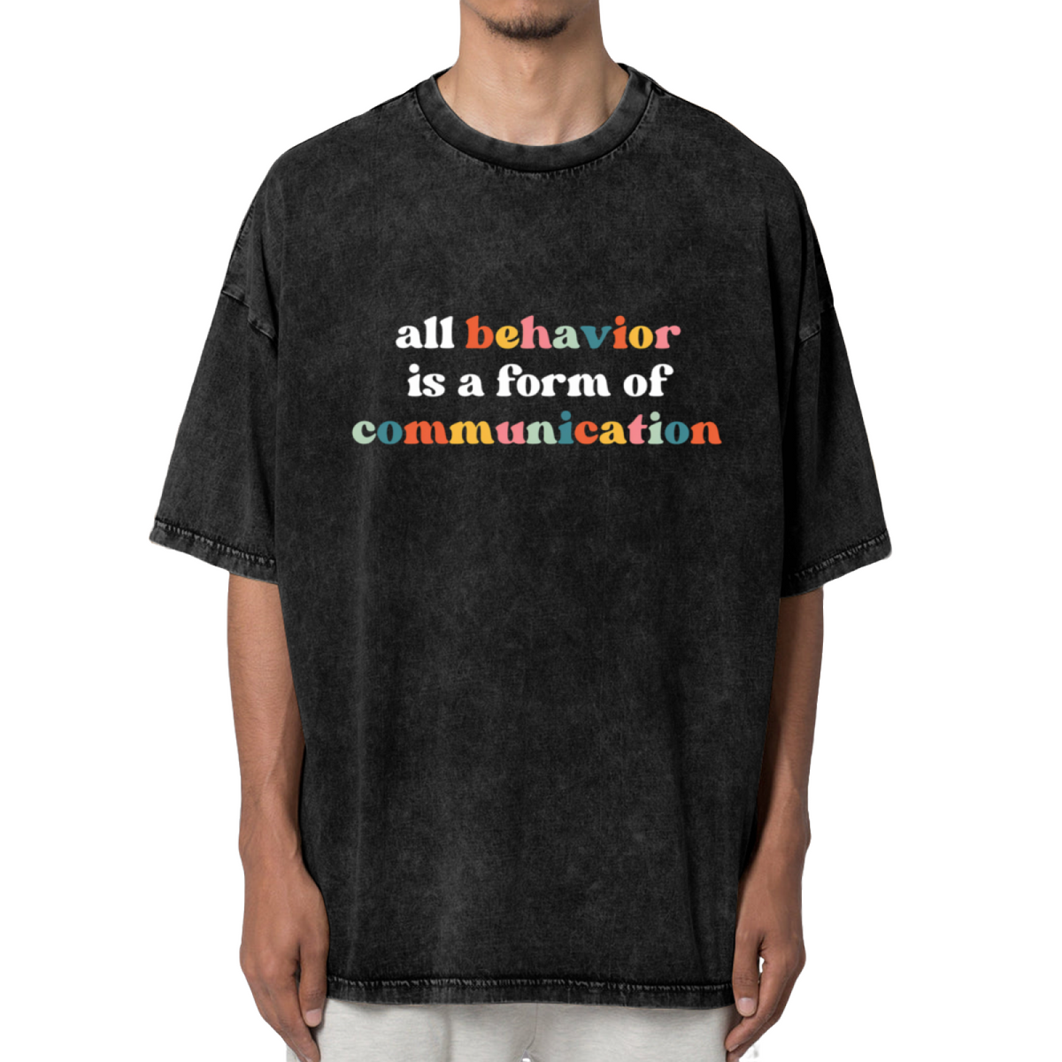 Product image of washed graphic T-shirt featuring 'All Behavior Is Communication' statement design
