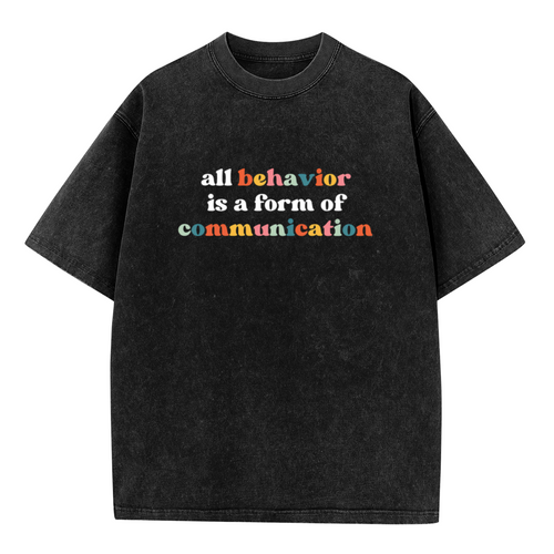 Product image of washed graphic T-shirt featuring 'All Behavior Is Communication' statement design